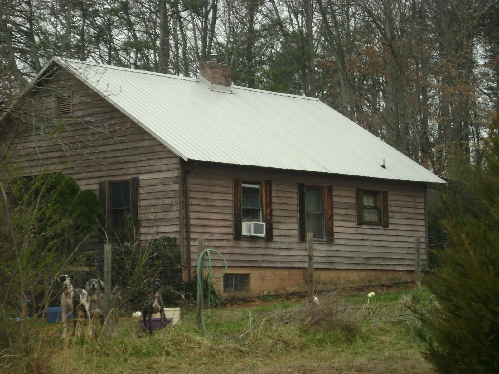 White metal roof on an old wood sided farmhouse, from a Metal Roof Installation job in Stone Ridge